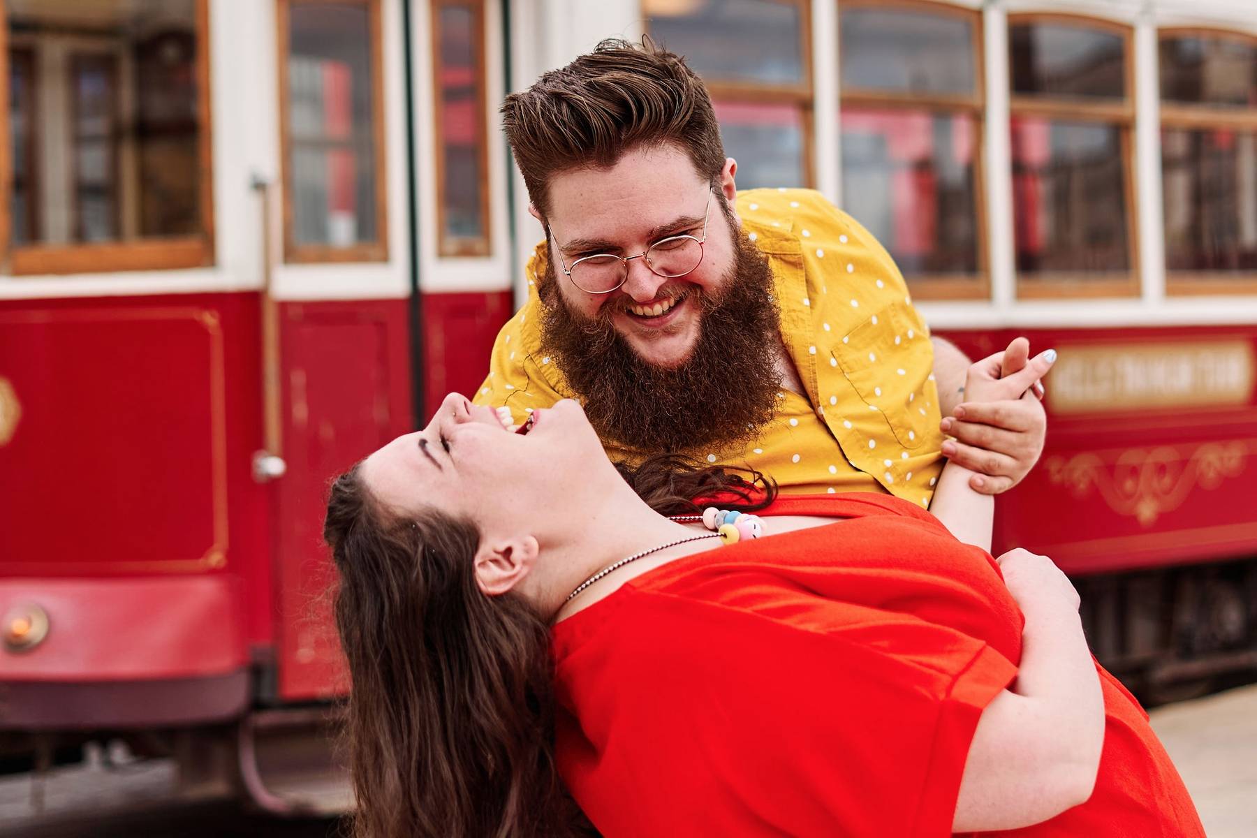 Michele &amp; Josh hug &amp; laugh in front of a cable car